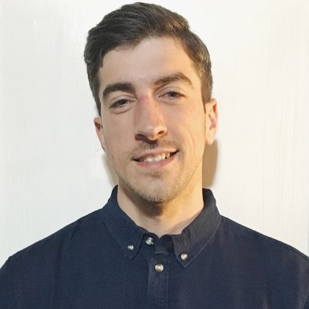 A headshot of Devin Hite, a white male with dark hair wearing a dark navy shirt against a white background.